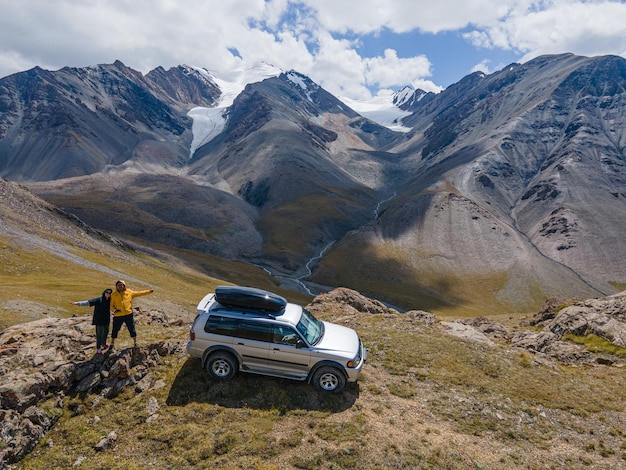 tourists by car on top of the mountain