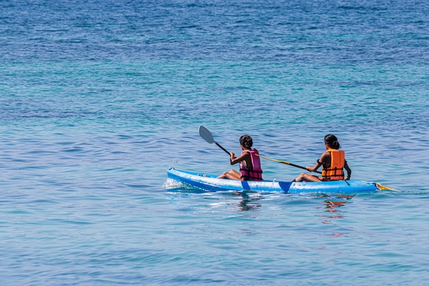 Tourists canoeing on the beautiful sea