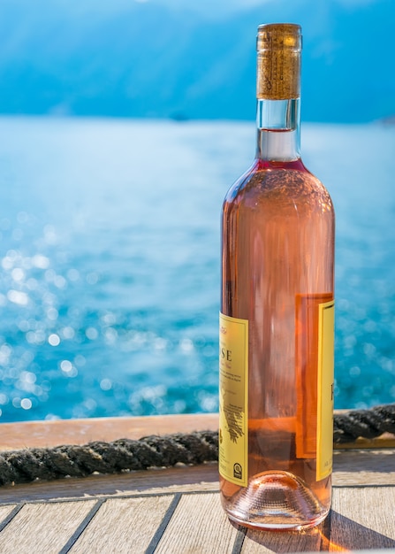 tourists drink pink wine, sailing on a yacht