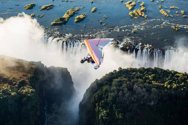 Tourists fly over the Victoria Falls on the trikes. Africa. Zambia. Victoria Falls.