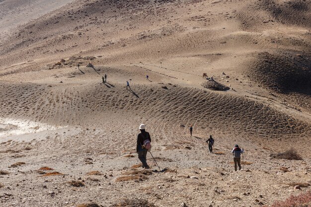 Tourists hiking in the mountains. Tourists descend from the mountains. Himalayas, Nepal.