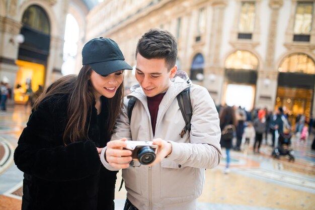 Tourists looking at the pictures shot in their trip