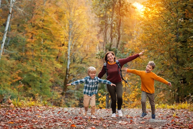 Tourists mother and children running in the forest