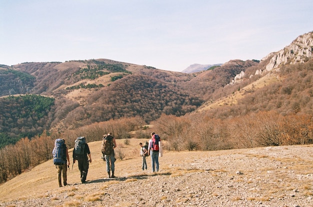 Tourists in the mountains in the autumn forest