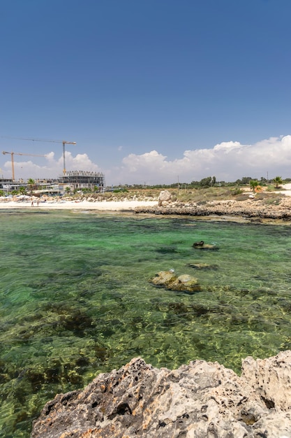 Tourists relax on the beautiful Ayia Thekla Beach