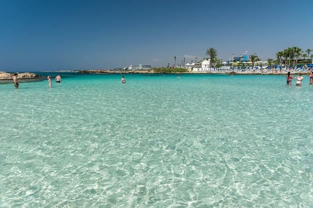 Tourists relax and swim on one of the most popular beaches on the island.