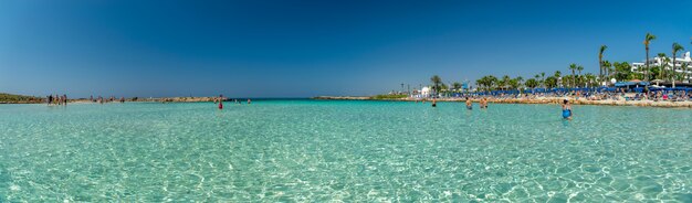 Tourists relax and swim on one of the most popular beaches on the island.