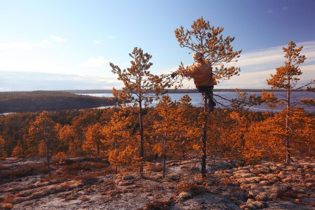 Tourists rest in the autumn at sunset mountains landscape