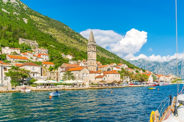 Tourists sailed on the yacht past the city of Perast in the Boka Bay of Kotor