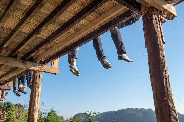 Tourists sitting legs hanging on terrace