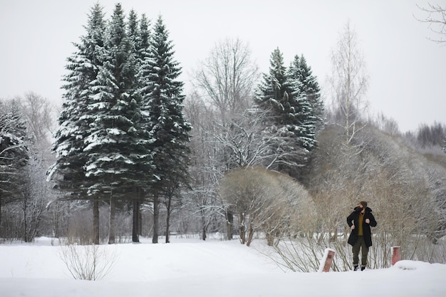 Tourists travel through the snowy country On the way walk and hitchhike