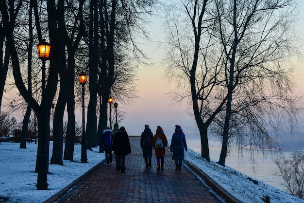 Tourists walk along the embankment of the Volga River