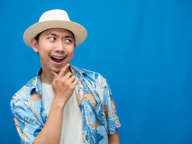 Toursim man wear hat beach shirt gesture thoughtful about holiday blue background