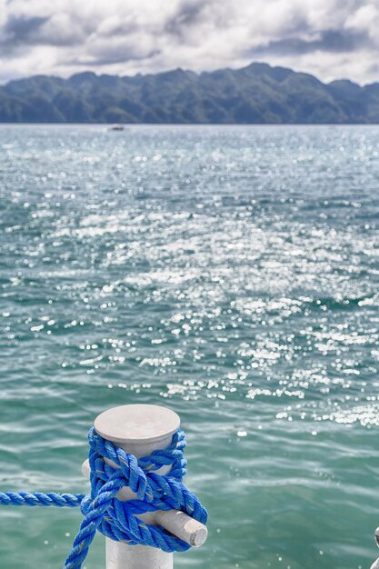 Foto touw vastgebonden aan bollard op zee tegen de lucht