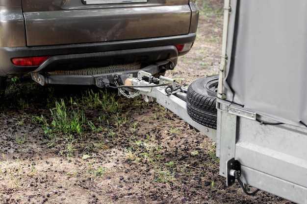 Photo tow hitch on a car trailer drawbar with spare wheel