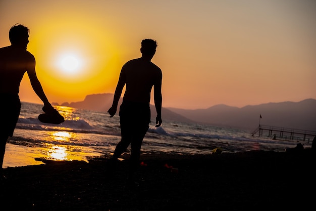 Tow persons walking together at the beach