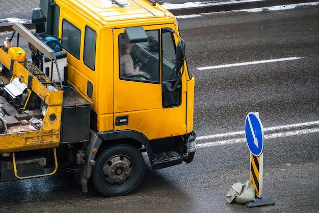 A tow truck on the road with a broken car on a trailer an accident on the road in the city evacuation of a broken car after an accident