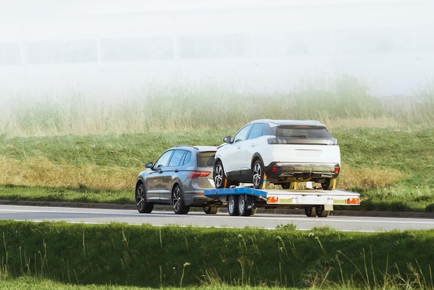Tow truck towing cars along highway