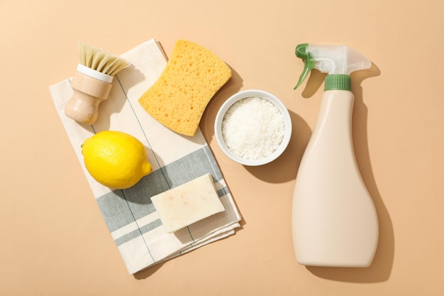 Towel brush sponge and ingredients for natural detergent on beige background top view