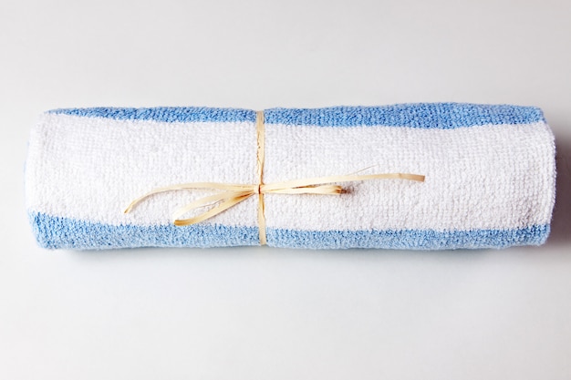 Towel twisted into a tubule on a white background