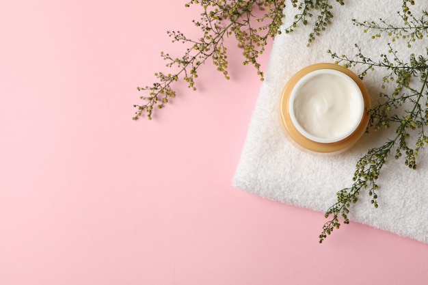 Towel with jar of cosmetic cream