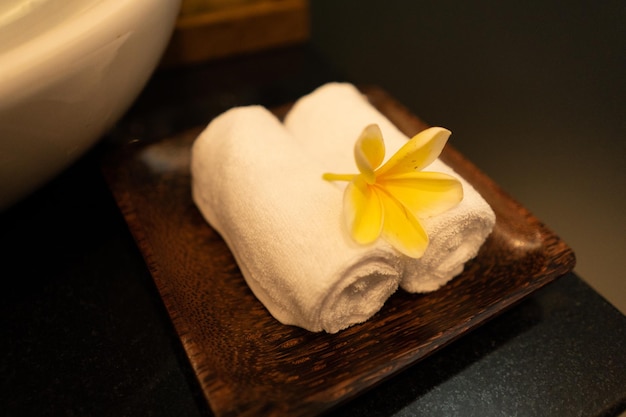 A towel with a yellow flower on it