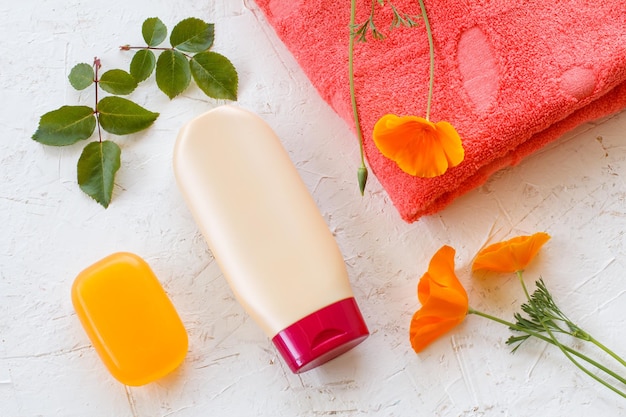 Towel and women cosmetics on a white background