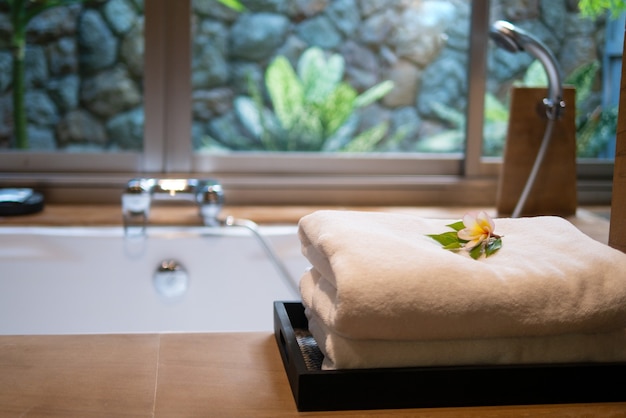 Photo towels on bath tub in resort hotel bathtoom for spa skin care hospitality on holiday vacation escape for mental health relief