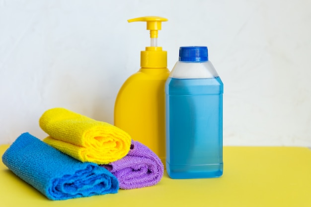 Towels and plastic bottles with cleaning products