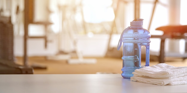 Towels and sport bottle with copy space in the gym