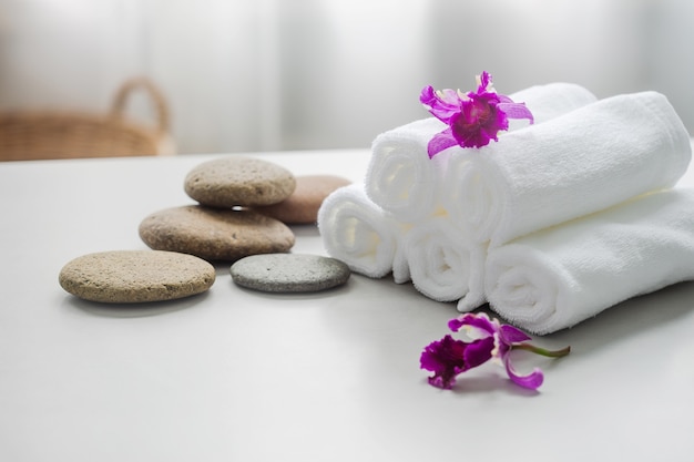 Towels on table with copy space blurred bathroom background.