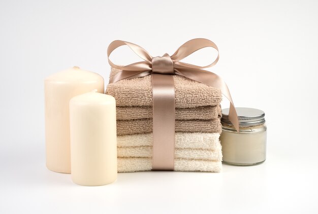 Towels tied with a gift ribbon and candles