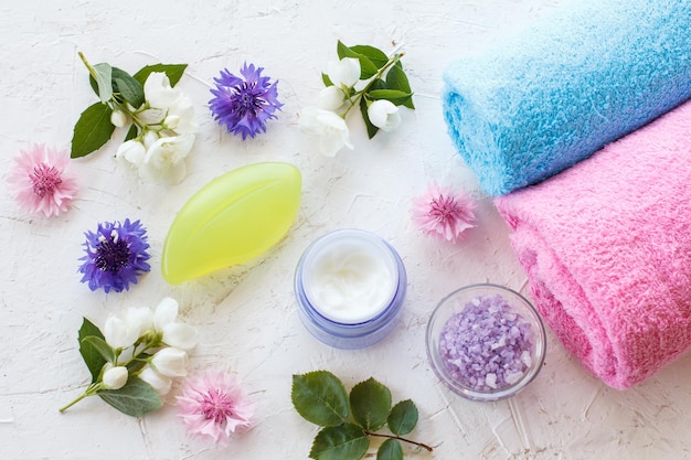 Towels and women cosmetics on a white background