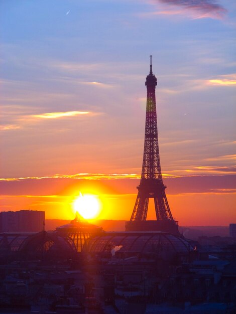 Photo tower against cloudy sky during sunset