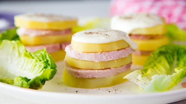Tower of boiled potatoes with slices of ham and mayonnaise Recipe for children