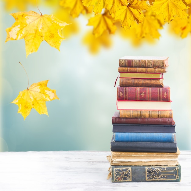 Tower of books on white wooden desktop