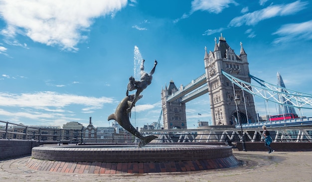 Tower Bridge and St Katharine Docks Girl with a dolpin fountain London UK