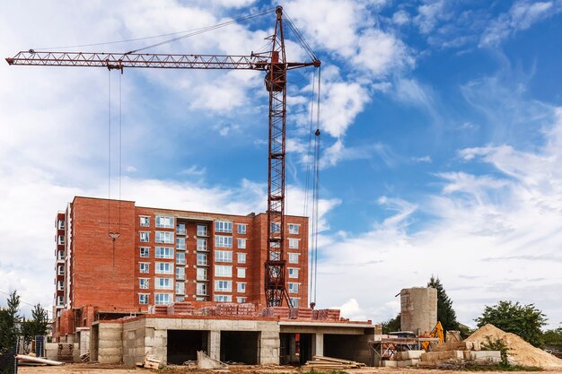 Tower crane on construction site on blue sky background