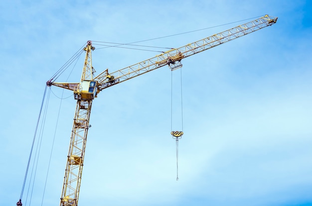 Tower crane on the sky background