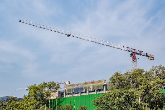 Photo tower cranes on construction site providing housing for lowincome citizens of third world countries