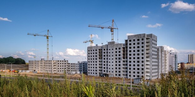 Photo tower cranes on construction site providing housing for lowincome citizens of third world countries