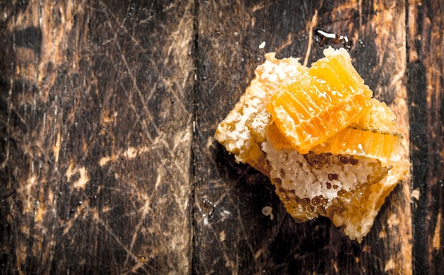 Tower of honeycomb. On the wooden background.