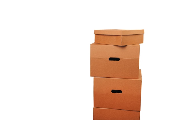 A tower made of some brown carton boxes over white background in a studio