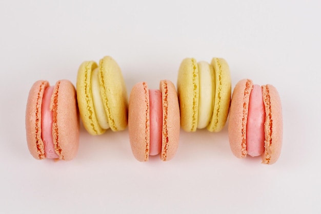 A tower of multicolored macaroons on a plain white background