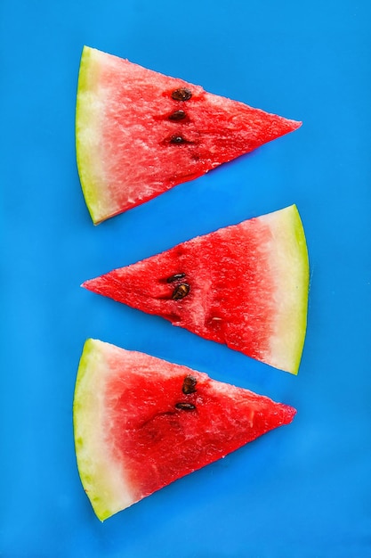 Tower of slices of watermelon on a blue background