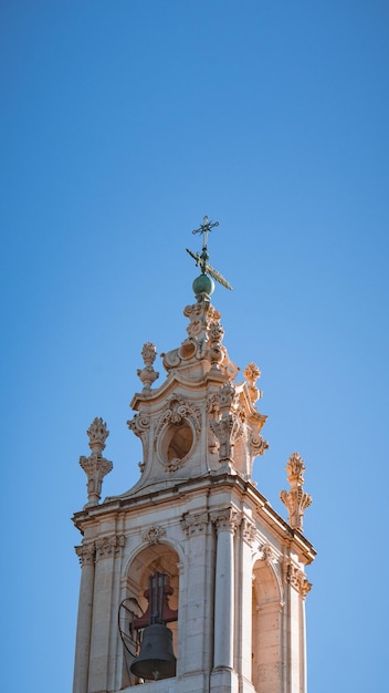 A tower with a cross on top of it