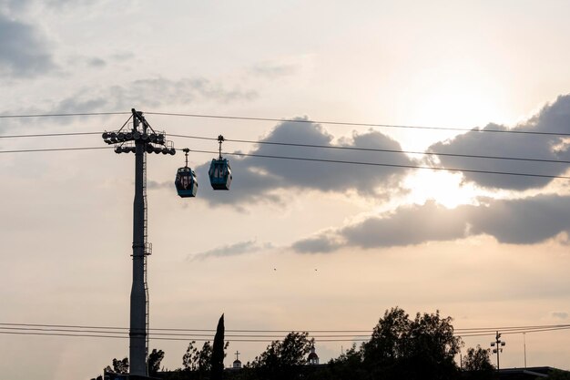 Tower with two teleferico or cablebus cabins in Mexico City with the sky in the background