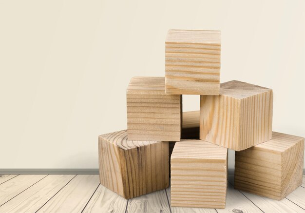 Tower of wooden cubes from table game over background