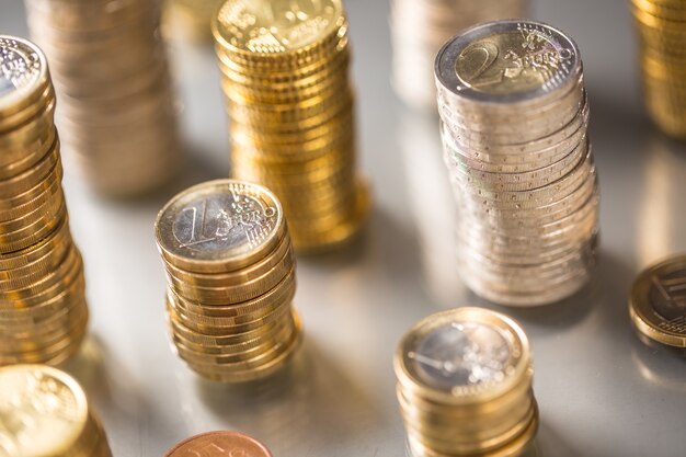 Towers of the euro coins stacked in different positions.