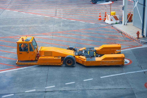 Towing vehicles in the airport waiting for the plane to be repaired